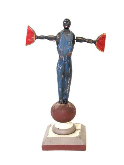 Appraisal: Carved and polychrome painted whirligig of a man holding watermelon