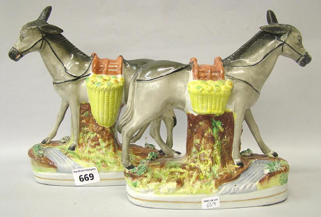 Appraisal: Pair of Staffordshire grey donkeys each carrying two yellow saddle