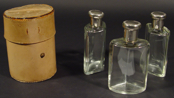 Appraisal: Set of three glass flasks with silver metal lids in