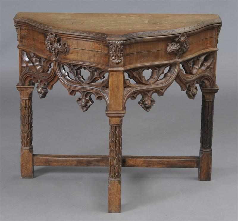 Appraisal: GOTHIC REVIVAL CARVED OAK CONSOLE TABLE The serpentine top with