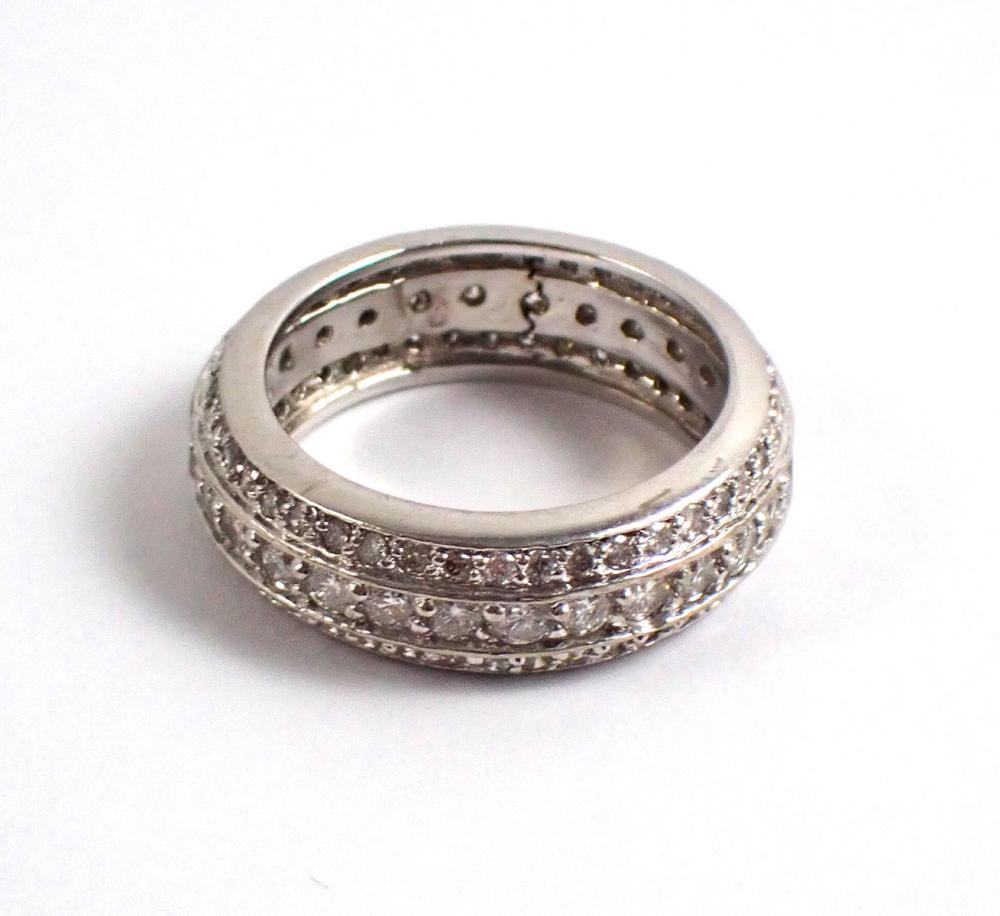 Appraisal: DIAMOND AND FOURTEEN KARAT WHITE GOLD ETERNITY RING pave' set