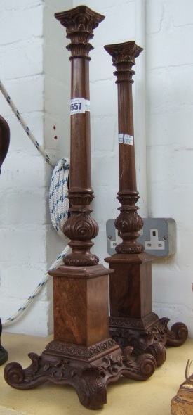 Appraisal: A pair of carved walnut candle sticks of Corinthian column