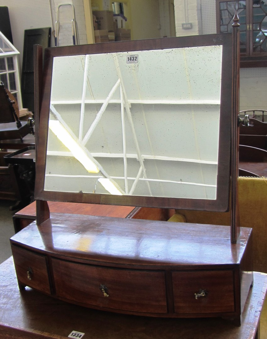 Appraisal: A George III mahogany toilet mirror with bowfront three drawer