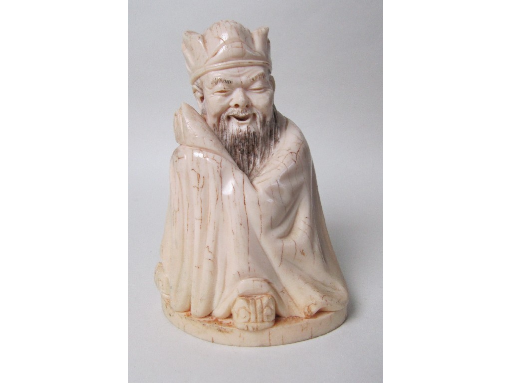 Appraisal: A Chinese ivory figure seated wrapped in a robe and