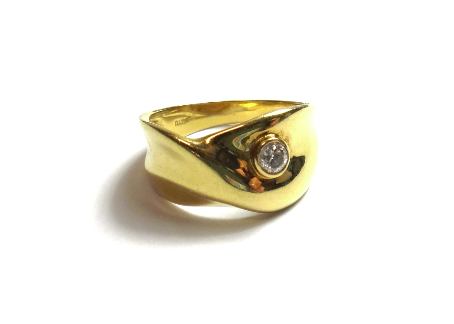 Appraisal: A gold and diamond set ring in an abstract design