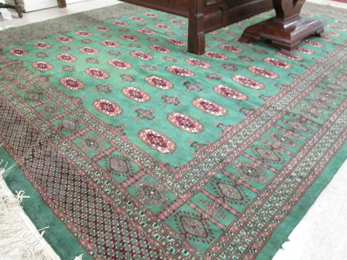 Appraisal: A GREEN FIELD BOKHARA CARPET India or Pakistan traditional Turkoman