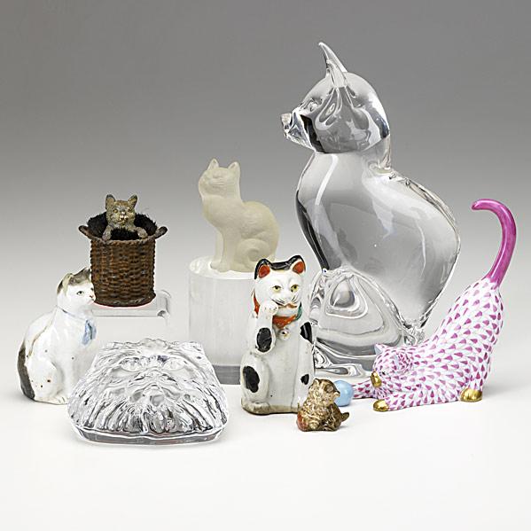 Appraisal: EIGHT CAT FIGURESIn porcelain metal and clear glass one by