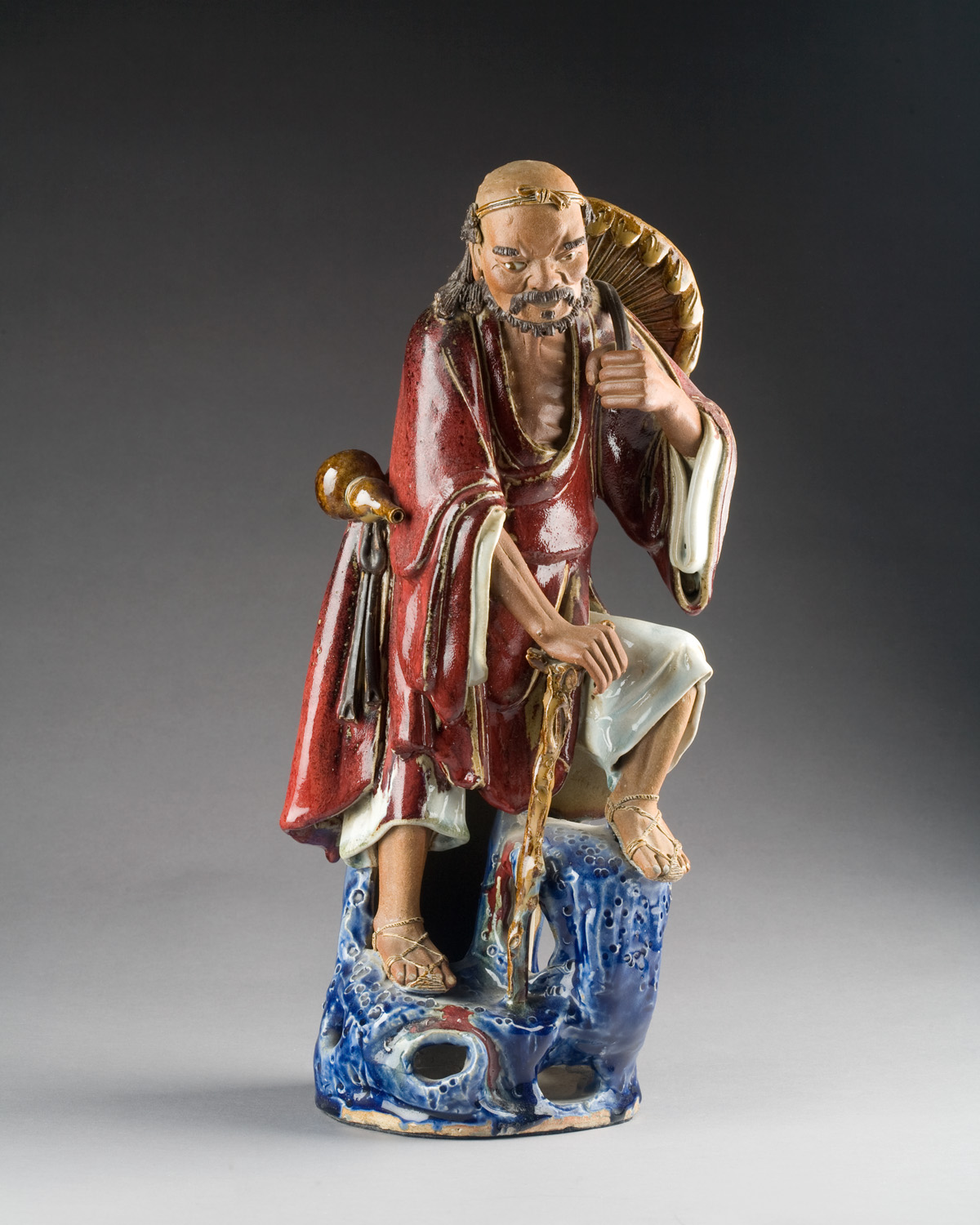 Appraisal: CHINESE POLYCHROME-PAINTED MUD FIGURE OF A TRAVELER CIRCA The robed