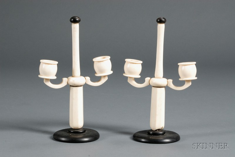 Appraisal: Pair of Ivory and Ebony Two-arm Candlesticks ebony button finials