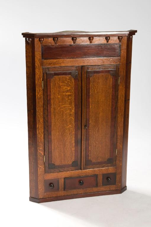 Appraisal: EARLY th CENTURY MAHOGANY CROSS-BANDED OAK CORNER CUPBOARD with projecting