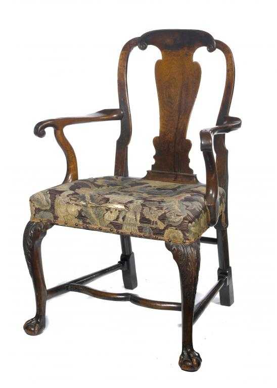 Appraisal: A GEORGE II WALNUT ARMCHAIR the back with spoon shaped