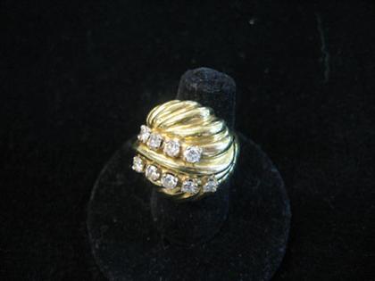 Appraisal: karat yellow gold and diamond dinner ring Bombe design knot