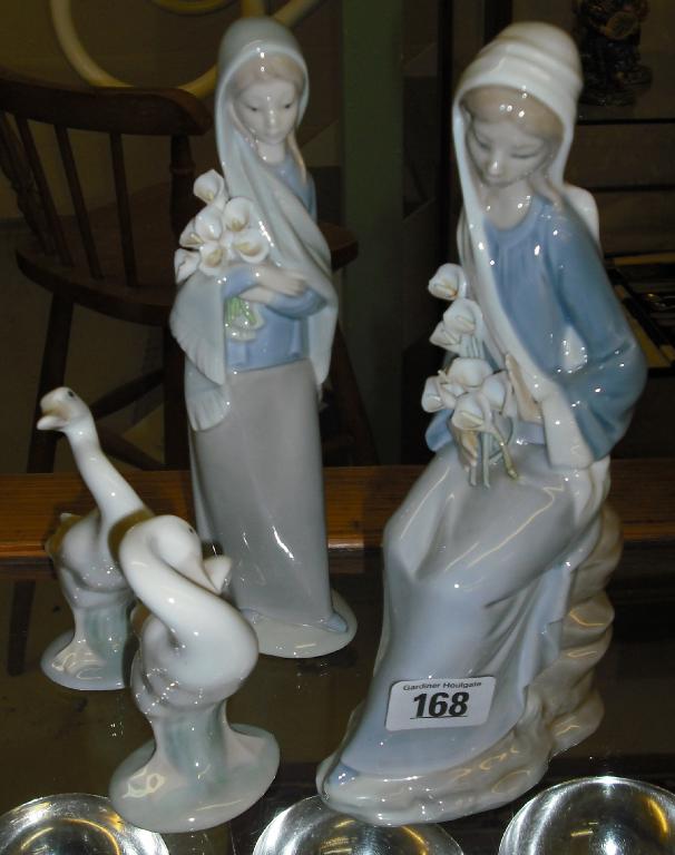 Appraisal: Two similar Lladro porcelain figures of ladies holding lilies together