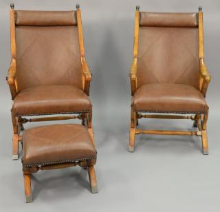 Appraisal: Pair of leather upholstered chairs with one footstool Pair of