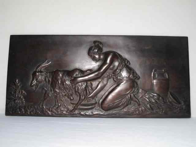 Appraisal: Victorian bronze hanging wall plaque Depicting a Victorian woman milking