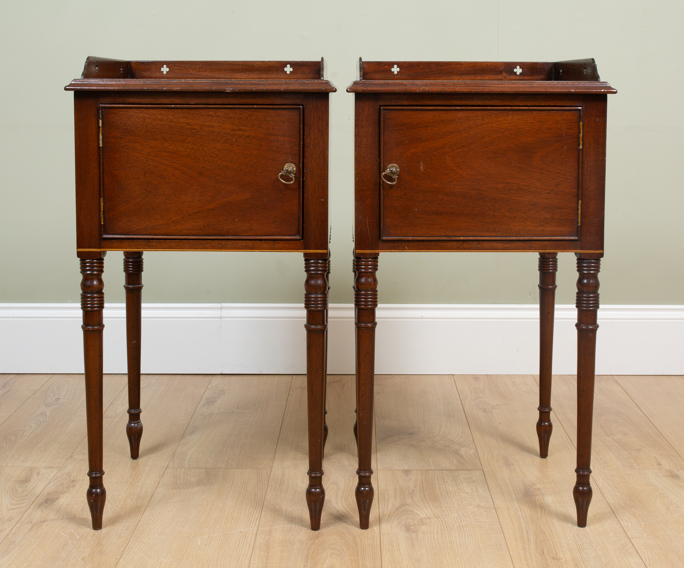 Appraisal: A pair of mahogany pot cupboards each with pierced galleries