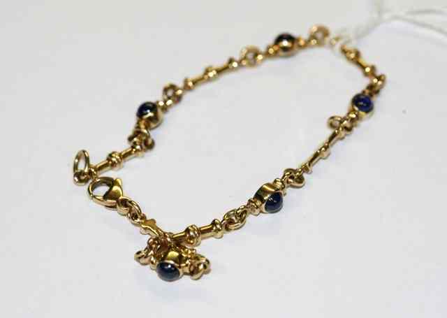 Appraisal: A GOLD AND SAPPHIRE SET BRACELET five cabochon cut sapphires