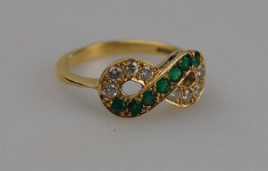 Appraisal: Emerald and diamond twist style ring set eight brilliant cut