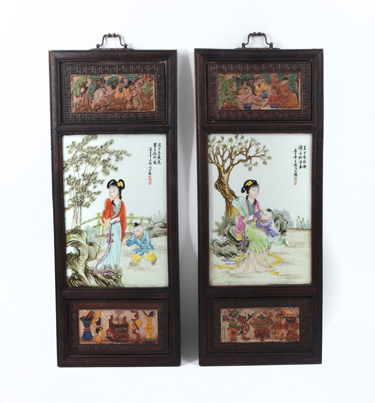 Appraisal: PAIR OF PAINTED CHINESE PLAQUES IN CARVED FRAMES framed Chinese