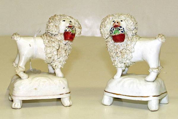 Appraisal: Two Staffordshire porcelain poodles with baskets second quarter th century