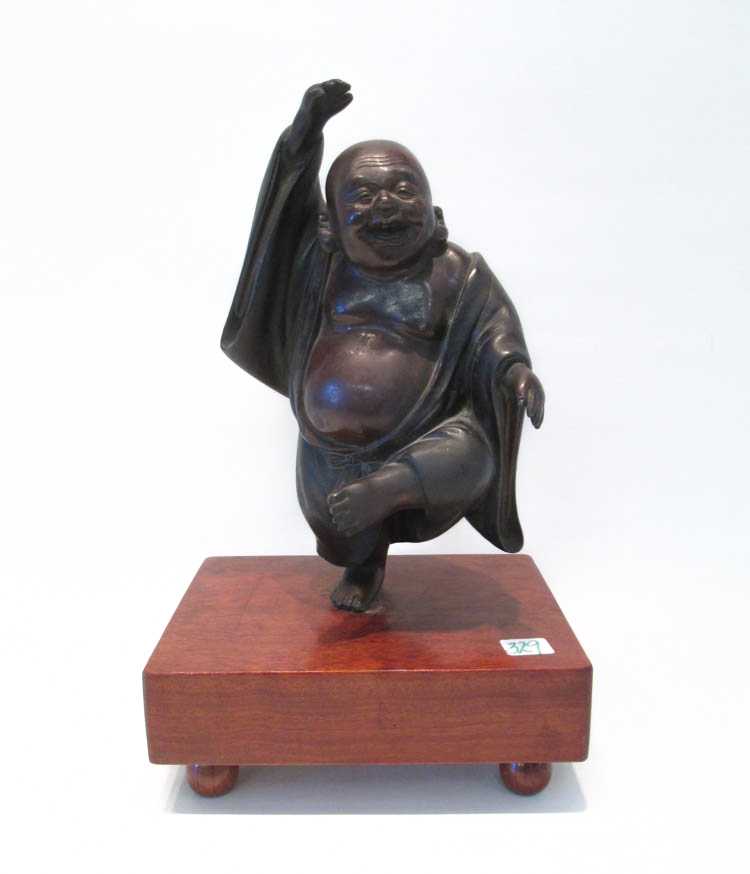 Appraisal: BRONZE LAUGHING BUDDHA SCULPTURES the figure playfully standing on one