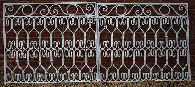 Appraisal: A PAIR OF WHITE PAINTED WROUGHT IRON GATES with repeating