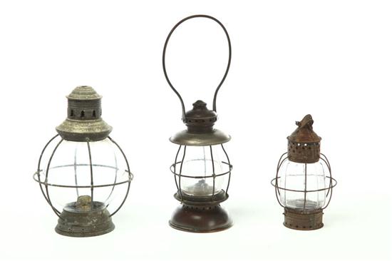 Appraisal: THREE LANTERNS American mid th century Glass globes with tin