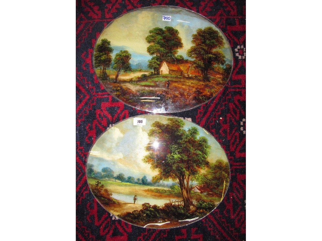 Appraisal: Two reverse painted oval glass plaques depicting a river scene