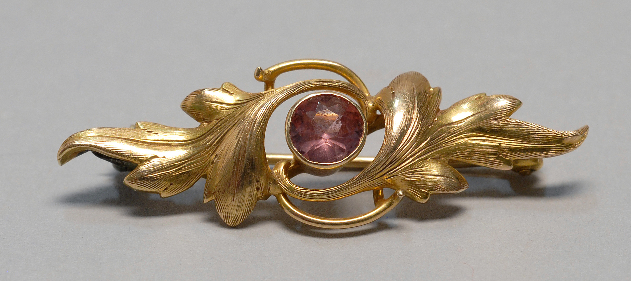 Appraisal: GOLD AND ROSE QUARTZ BROOCH with a central stone surrounded