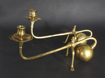 Appraisal: A pair of brass candlesticks in the manner of W