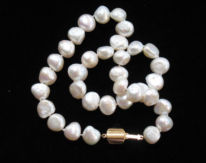 Appraisal: A STRING OF WHITE BAROQUE PEARLS set as a necklace