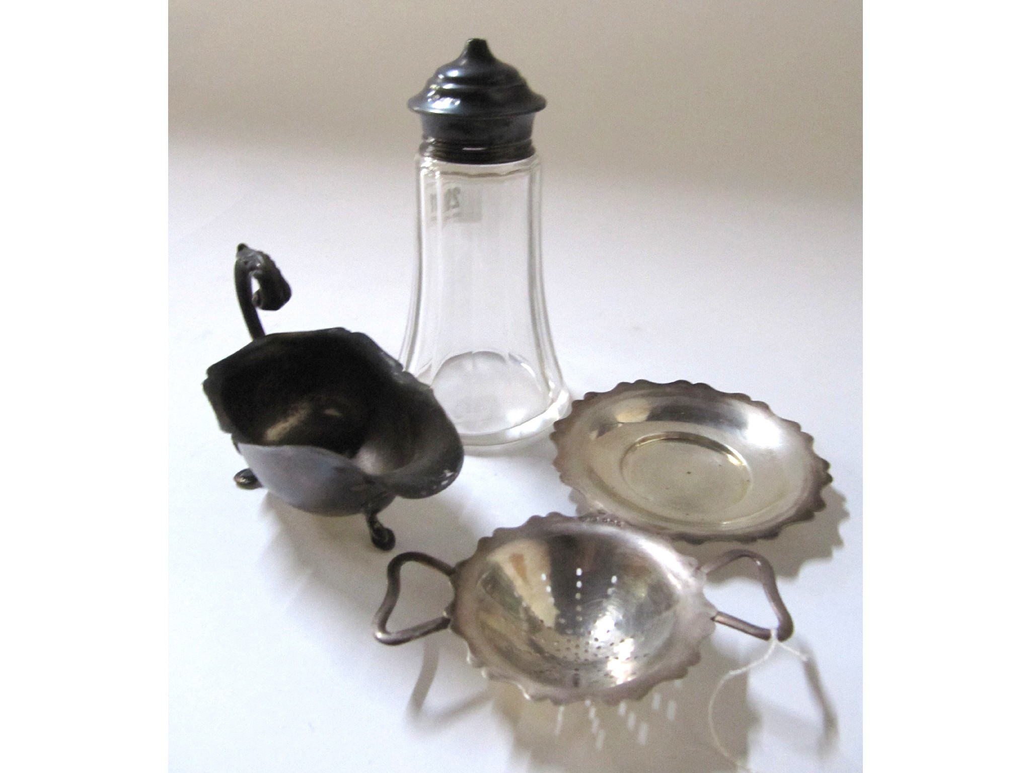 Appraisal: A lot comprising a silver sauceboat dish strainer and silver