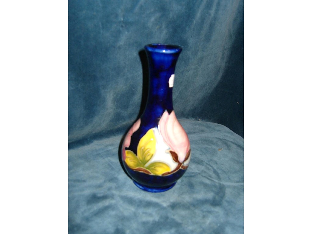 Appraisal: A blue ground Moorcroft vase with drawn neck and pink