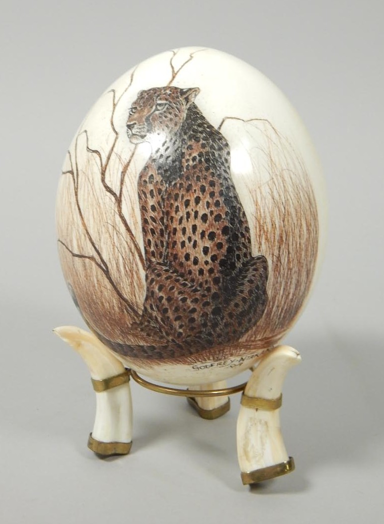 Appraisal: Godfrey Nakana Cheetah in landscape painting on ostrich egg warthog