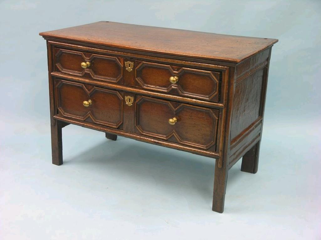 Appraisal: A late th century oak chest two graded drawers each