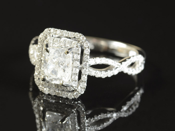 Appraisal: DIAMOND AND FOURTEEN KARAT WHITE GOLD RING having round-cut diamonds