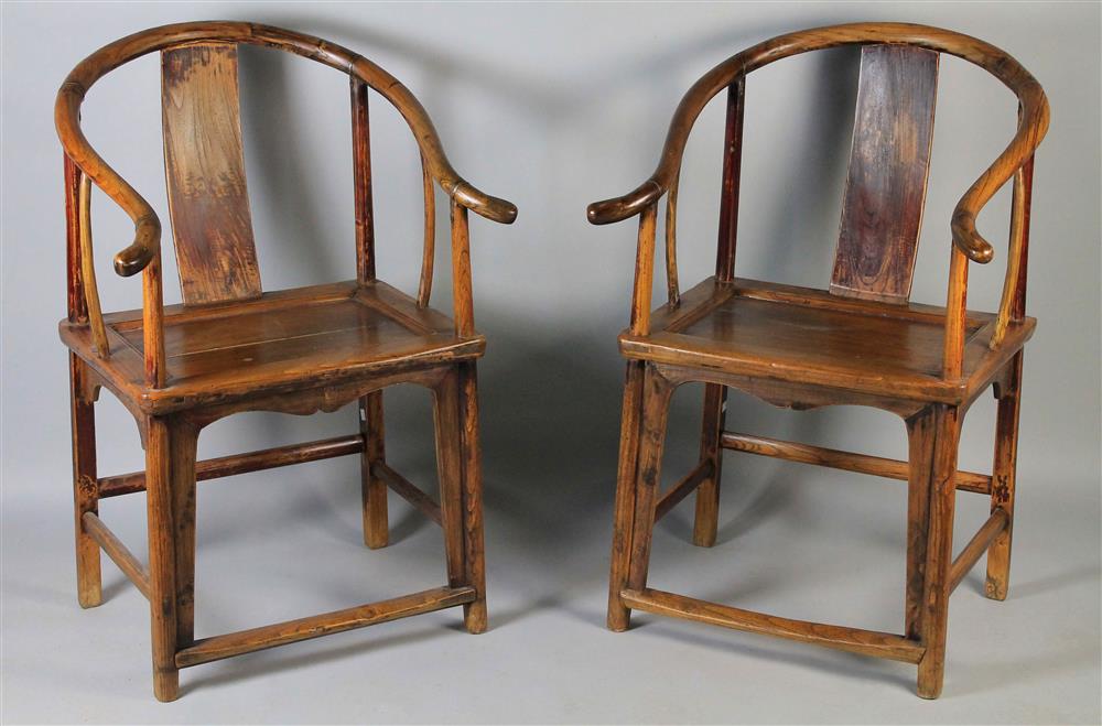 Appraisal: PAIR OF CHINESE HARDWOOD HORSESHOE ARM CHAIRS having a typical