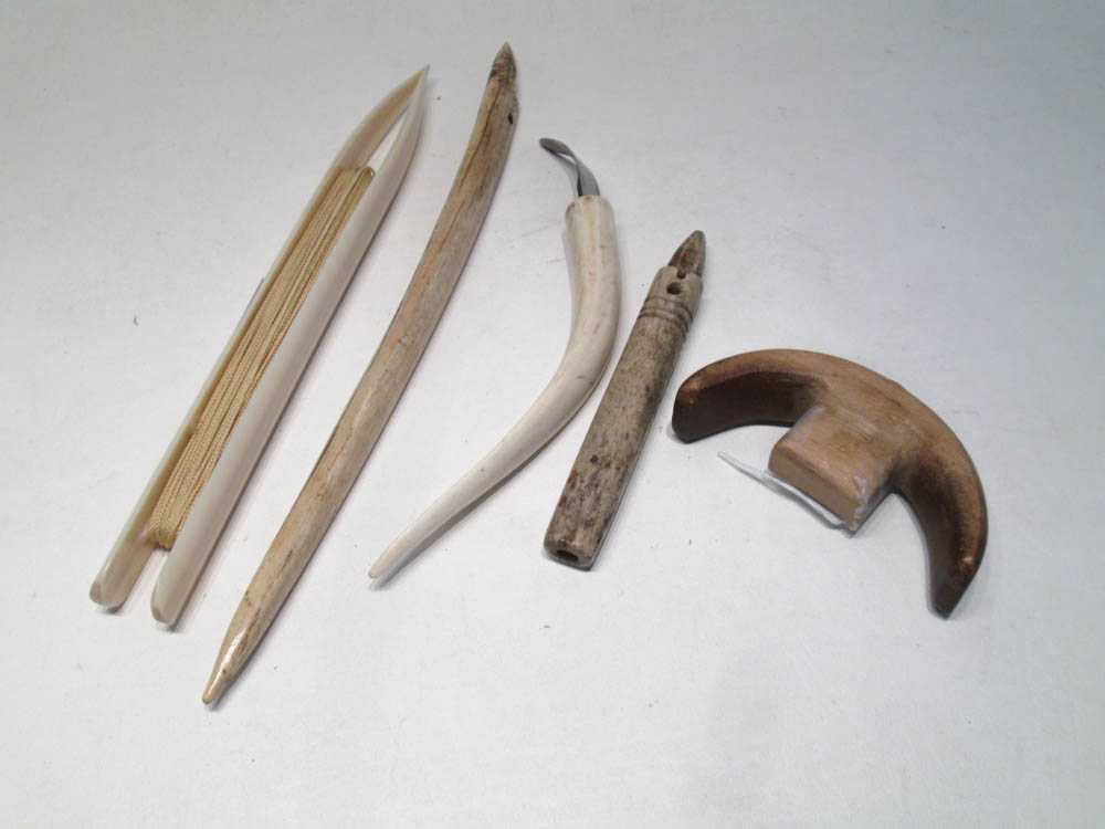 Appraisal: FIVE PIECES OF ESKIMO BONE AND WOOD IMPLEMENTS including a