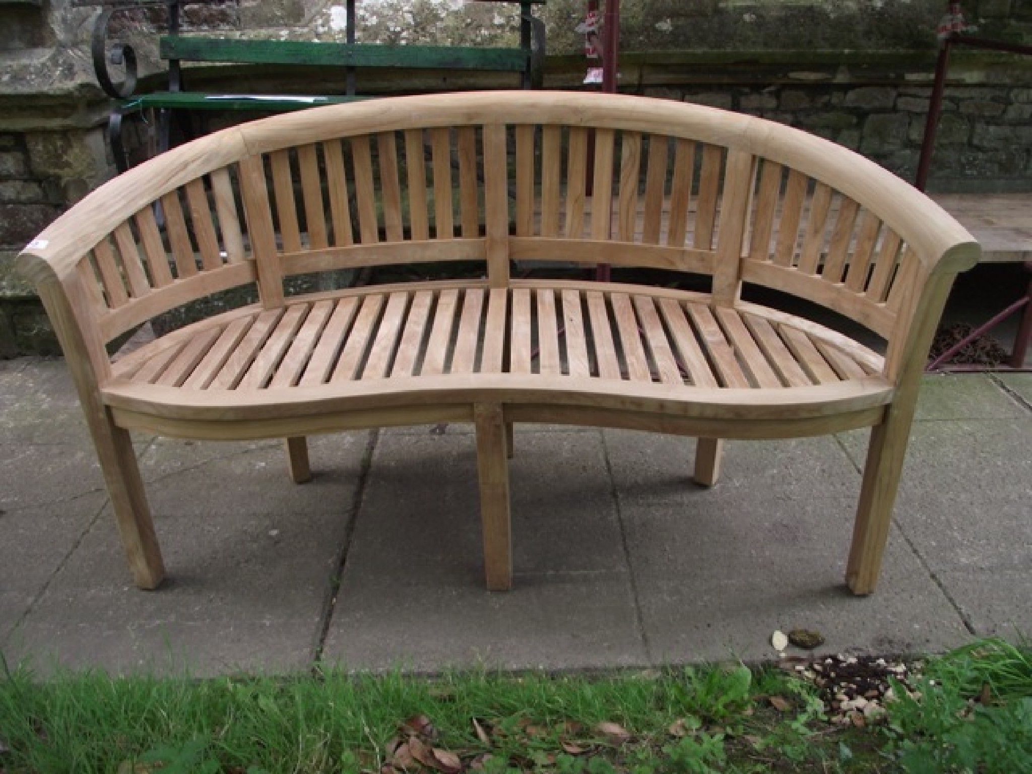 Appraisal: A contemporary teak 'banana' bench