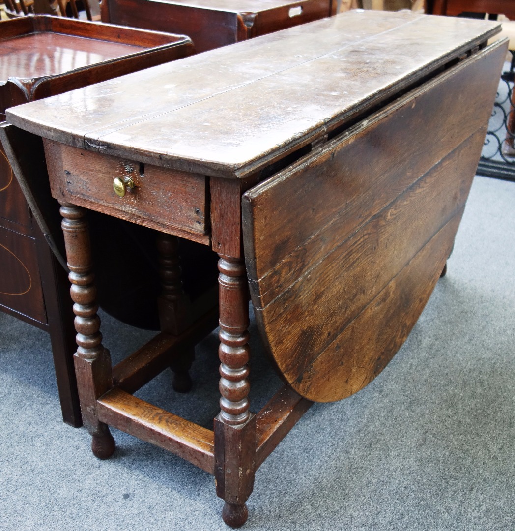 Appraisal: A th century oak drop flap dining table with end