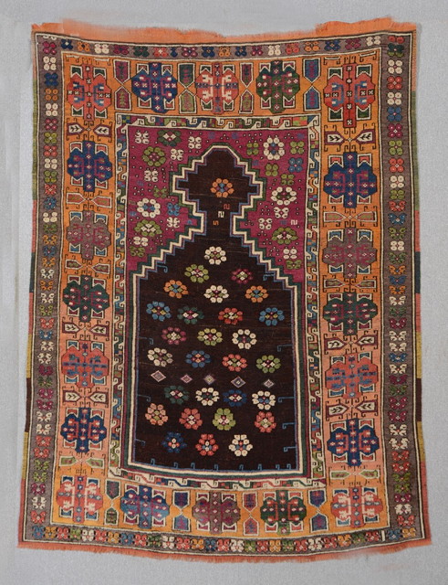 Appraisal: AN ANTIQUE TURKISH PRAYER RUG with central panel decorated flower