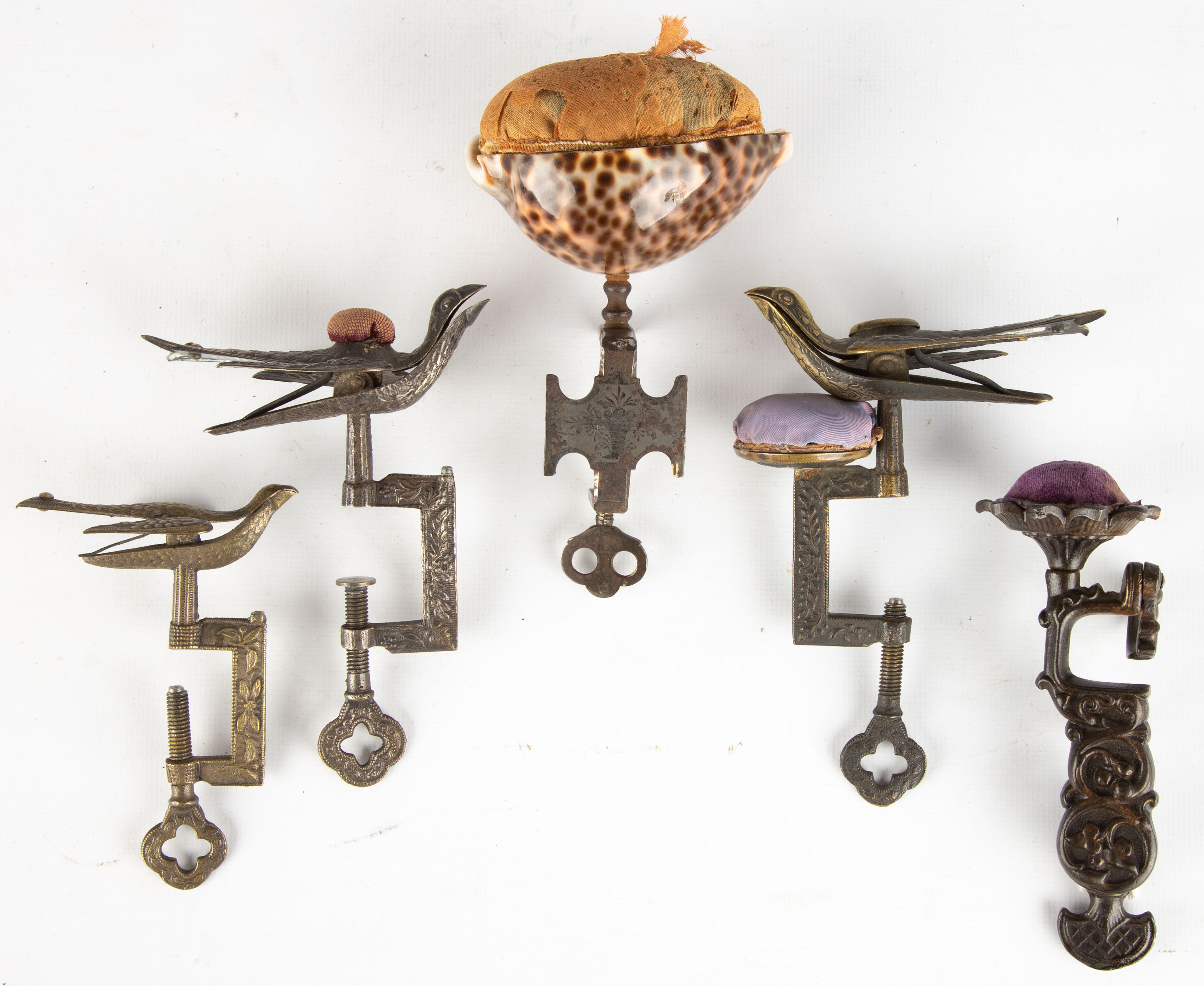 Appraisal: ANTIQUE SEWING BIRDS metal with pin cushions one has cowrie