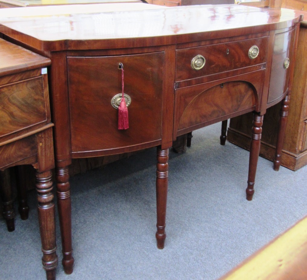 Appraisal: A Regency mahogany bowfront sideboard on turned supports cm wide