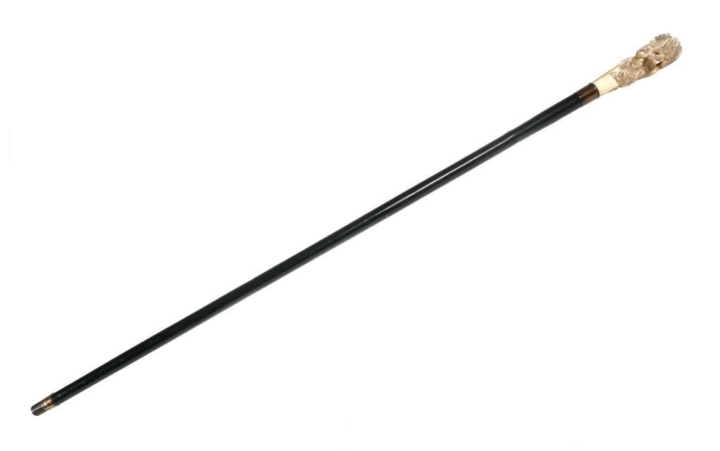 Appraisal: This heavy walking stick cane is made of dark-colored wood