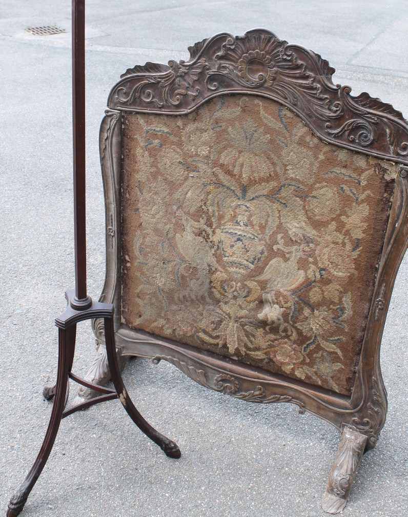 Appraisal: A heavily carved continental firescreen with embroidered centre cm high