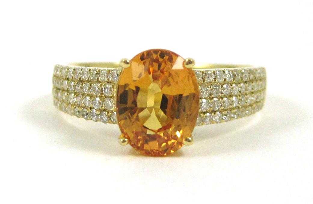 Appraisal: YELLOW SAPPHIRE AND FOURTEEN KARAT GOLD RING with round-cut diamonds