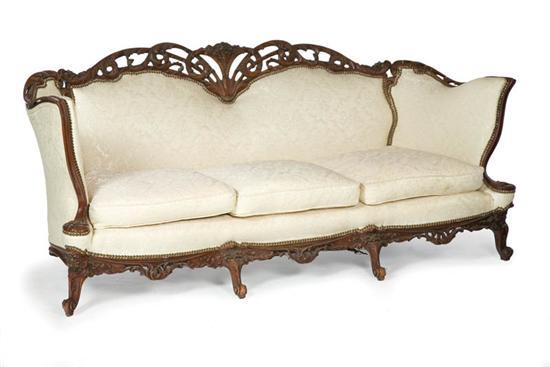 Appraisal: ROCOCO REVIVAL SOFA American early th century mahogany Elaborately foliate