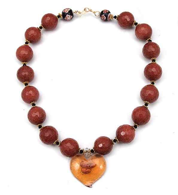 Appraisal: A CAMPOS ORIGINAL GOLDSTONE BEAD NECKLACE WITH HEART PENDANT Dichroic