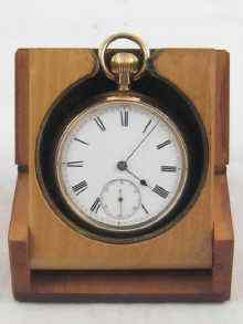 Appraisal: A gold plated pocket watch in travelling stand