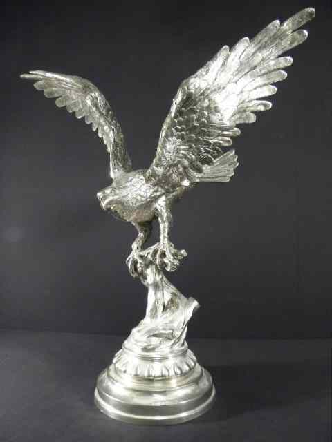 Appraisal: Large metal sculpture of a perched eagle in a silvered